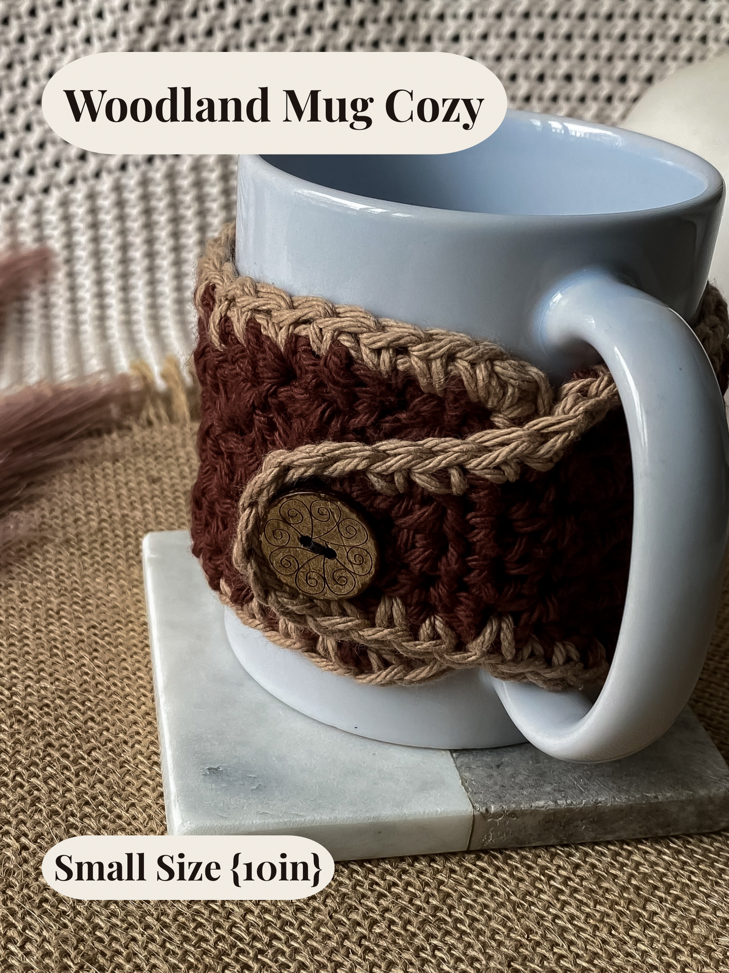 White mug with a brown crochet mug cozy on a marble coaster, on a textured surface.