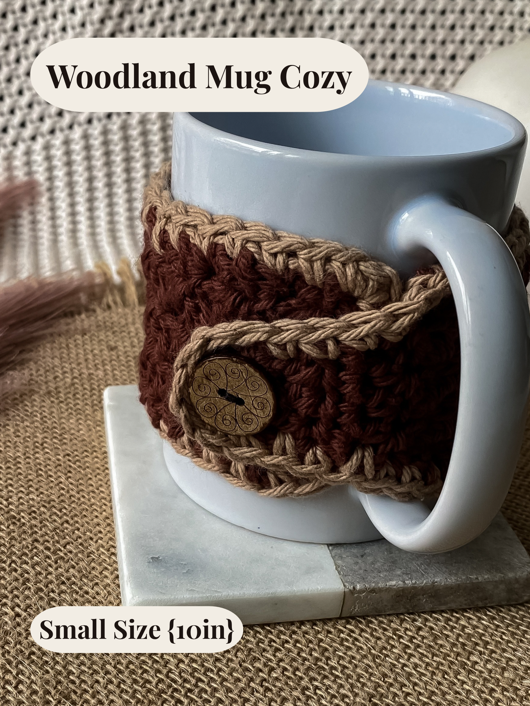 White mug with a brown crochet mug cozy on a marble coaster, on a textured surface.