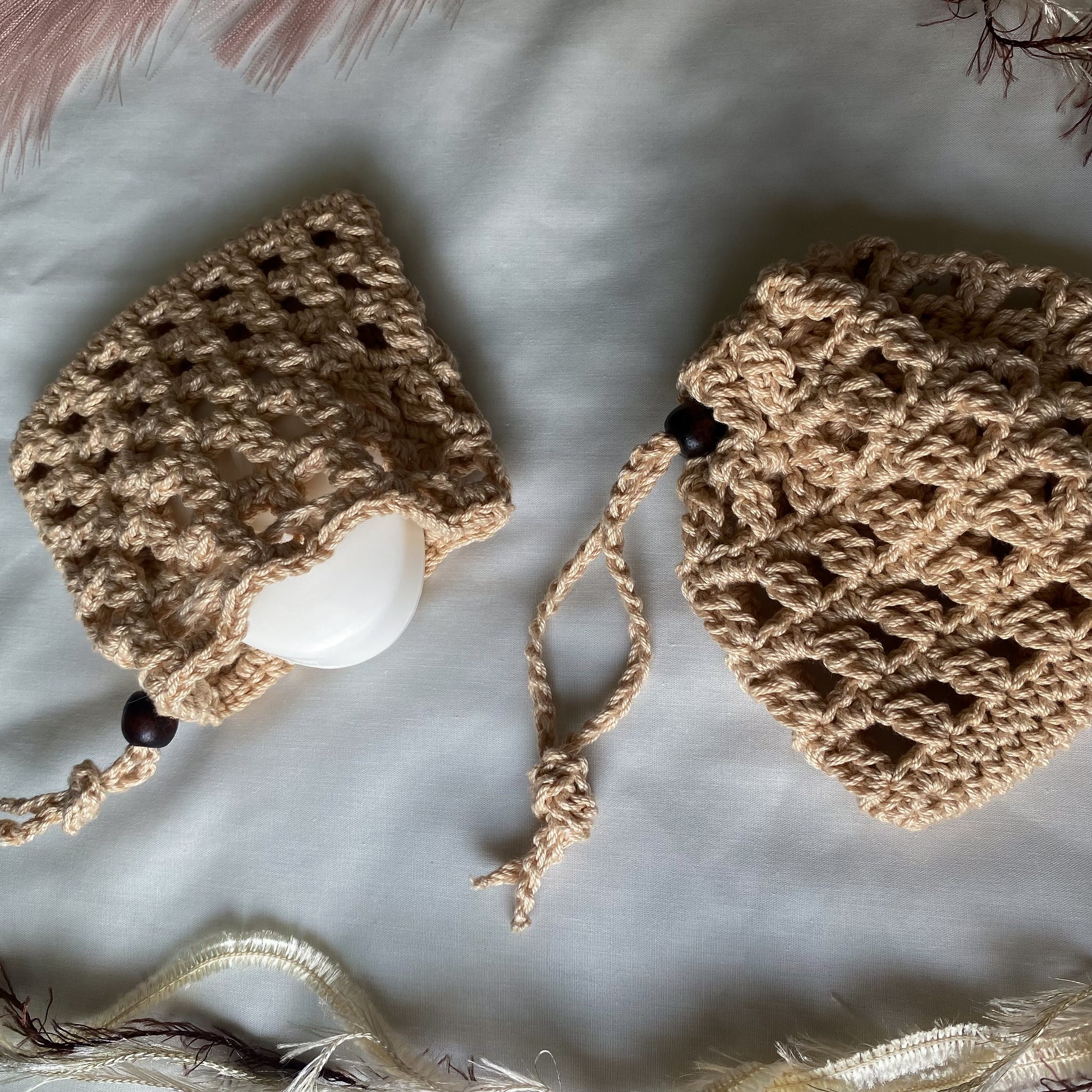 Two crocheted hats on a light background with decorative elements.