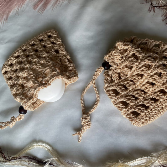 Two crocheted hats on a light background with decorative elements.